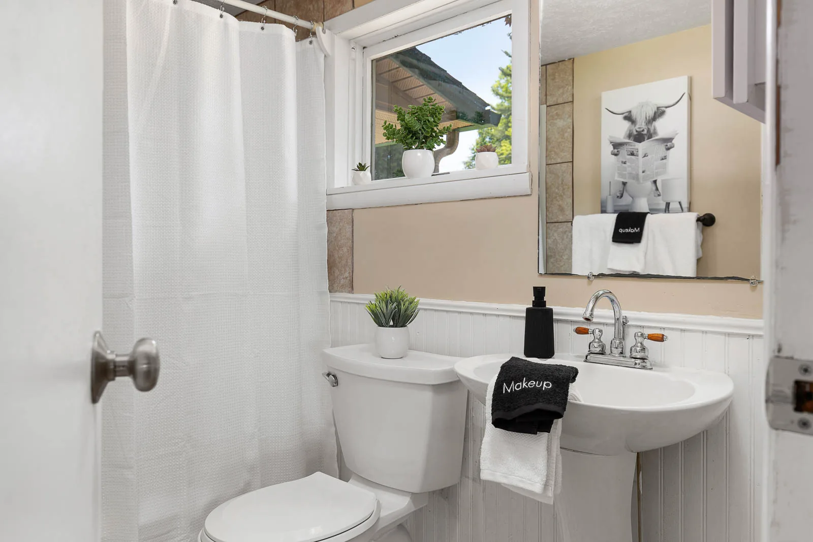 Bathroom sink, towels, and shower in The House