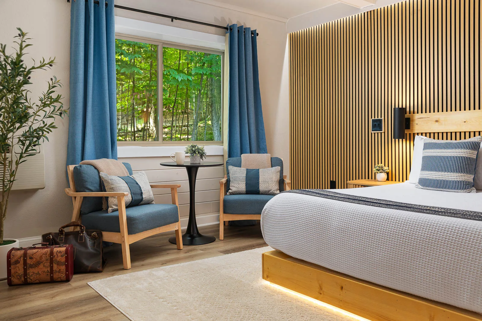 King Lodge Suite bed beside a window and lounge chair