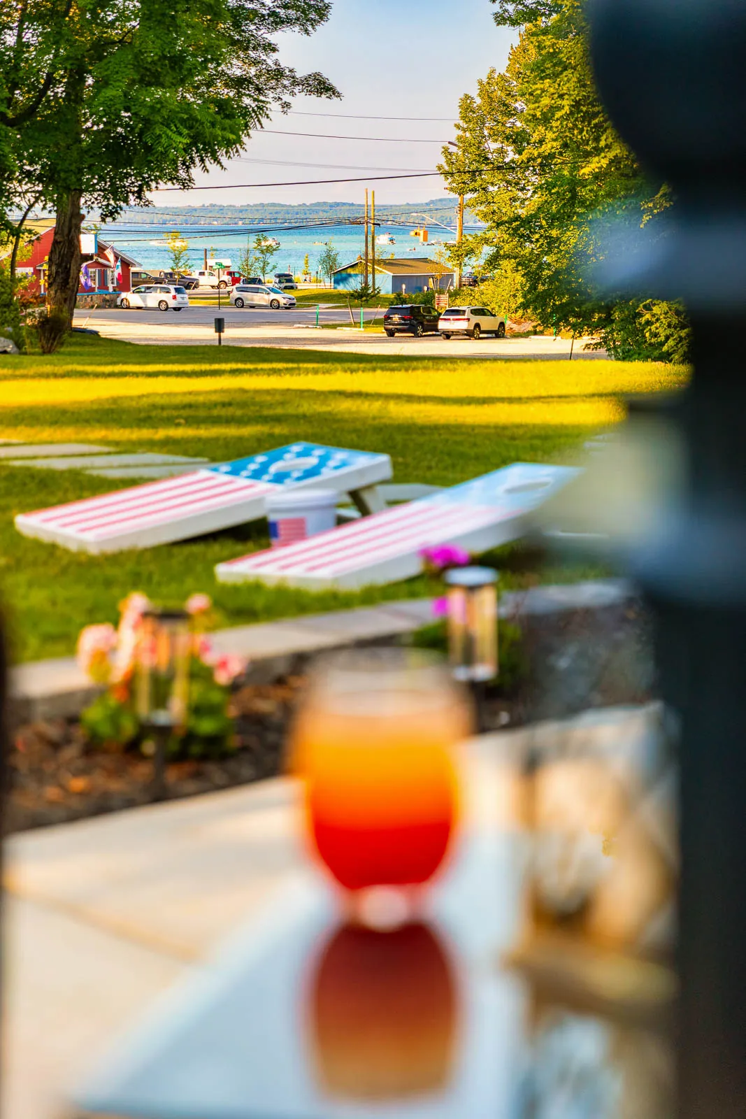 Cornhole boards on the lawn with Torch Lake beyond