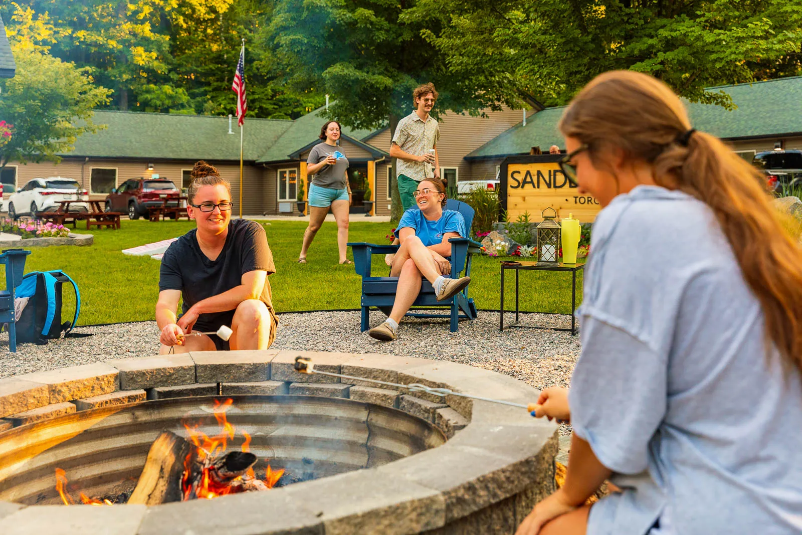 Guests roasting marshmallows around the firepit