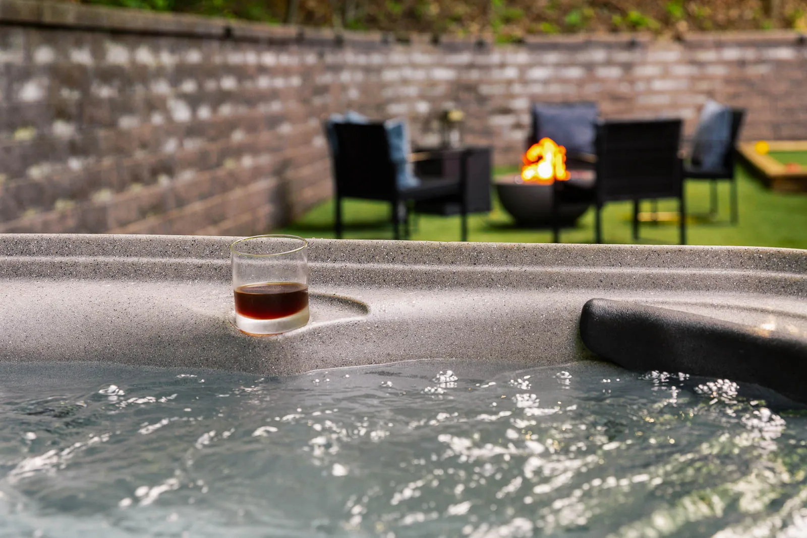 Hot tub with firepit lounge in the background