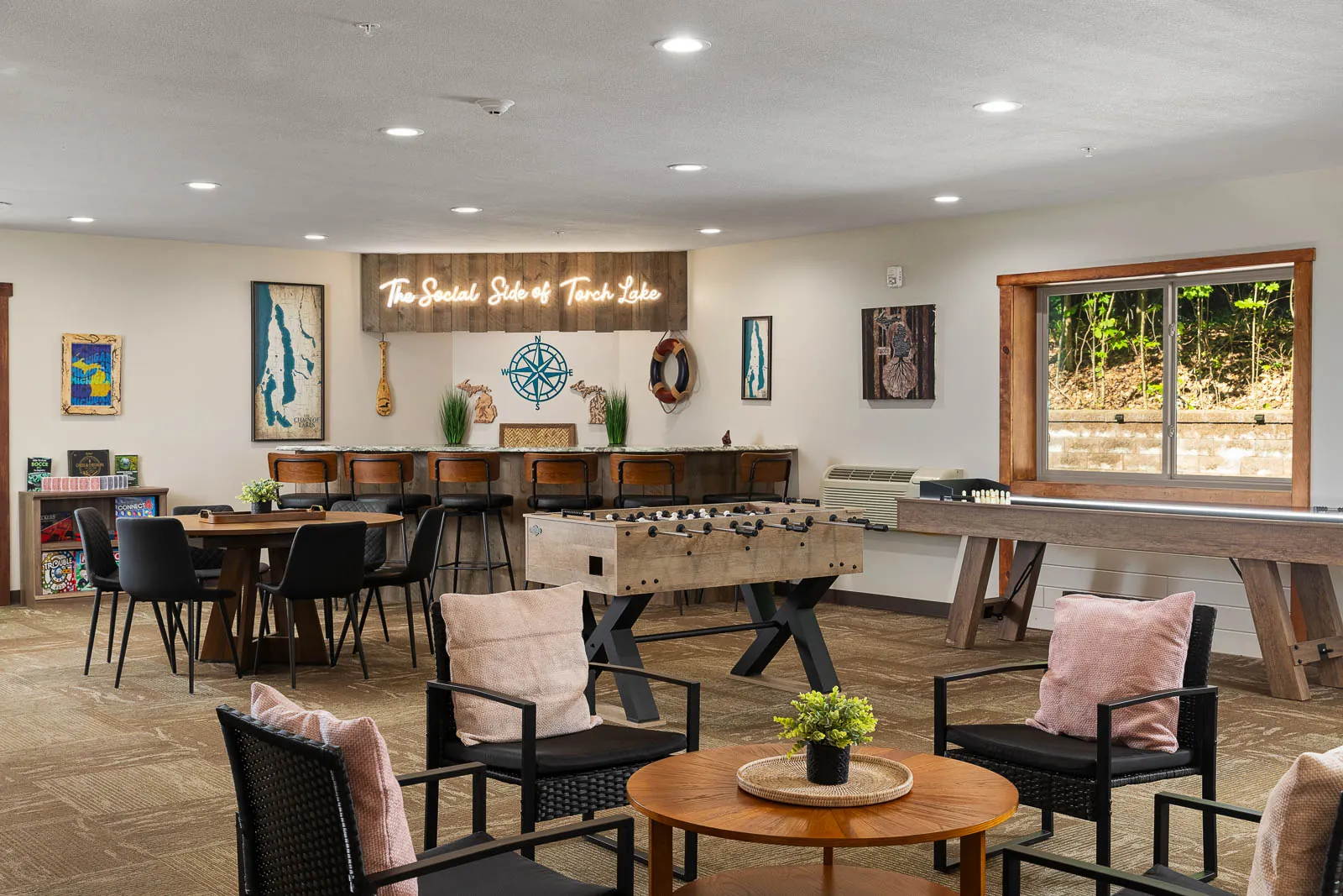 Indoor lounge with foosball, shuffleboard, and bar seating