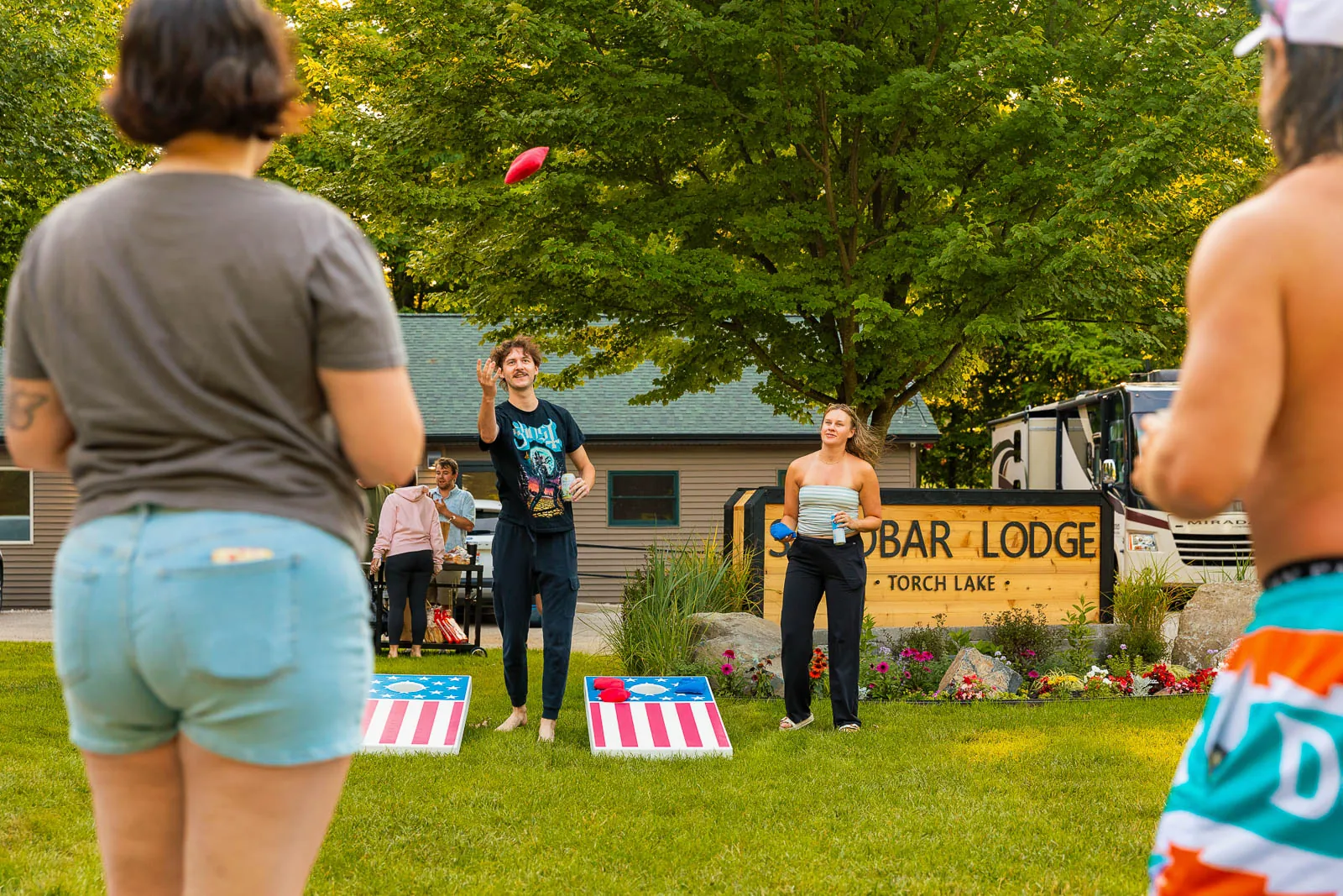 Guests playing cornhole on the lawn