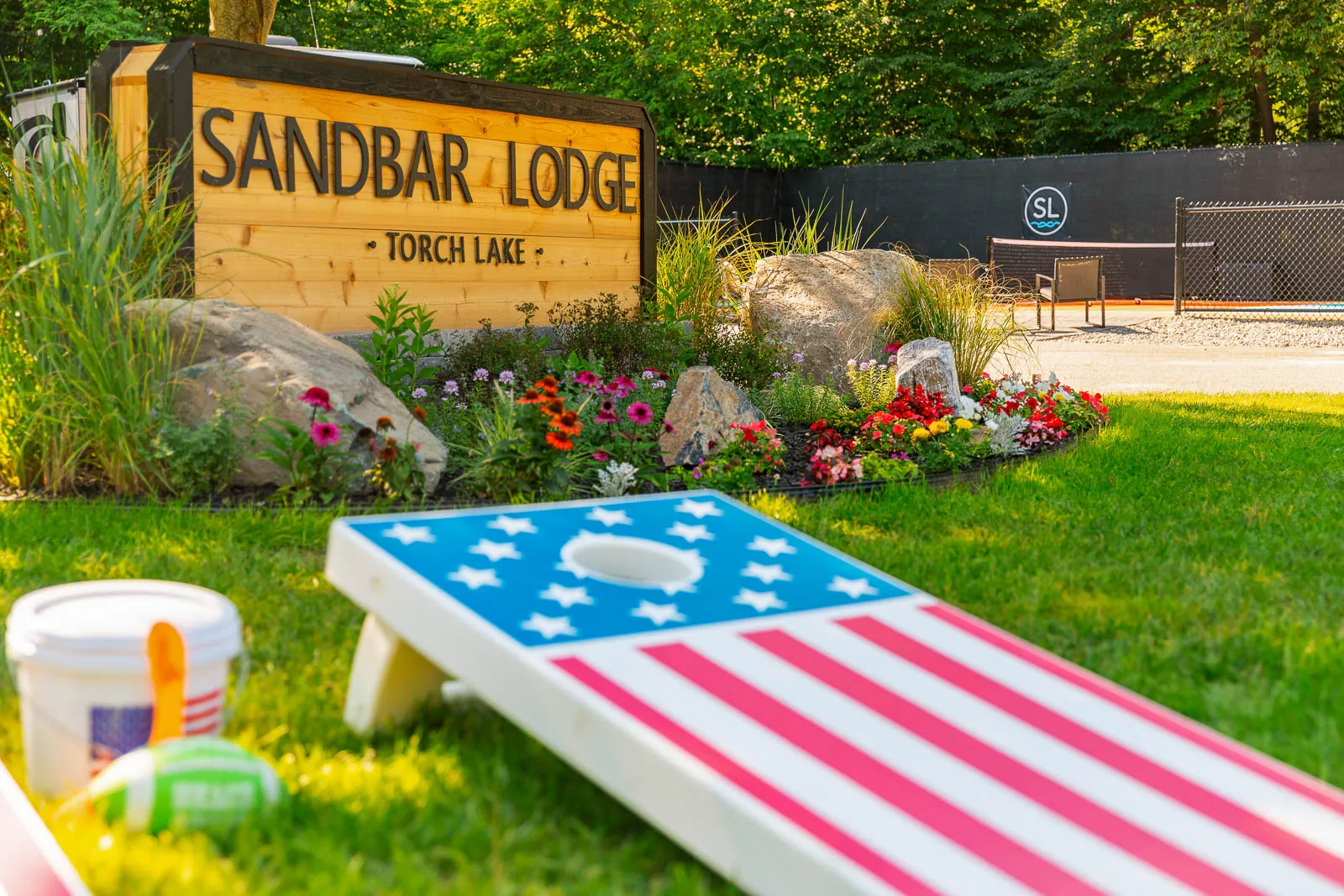 Sandbar Lodge sign with cornhole boards in front