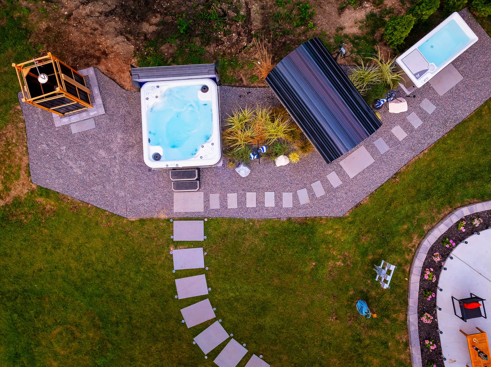 Evening aerial of the hot tub, sauna, and cold plunge
