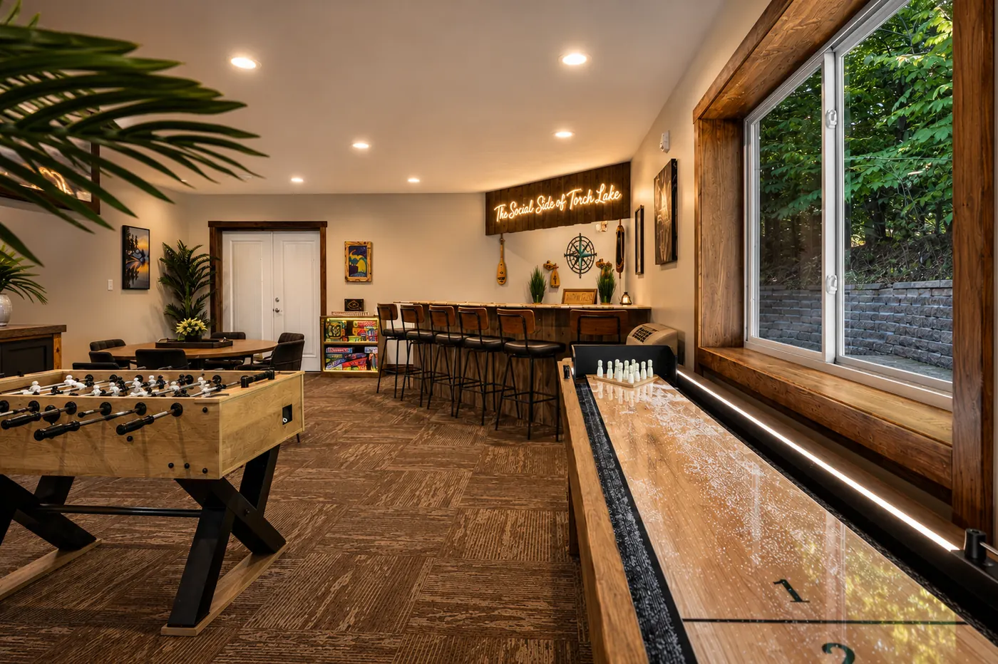 Indoor hangout room with shuffleboard and foosball
