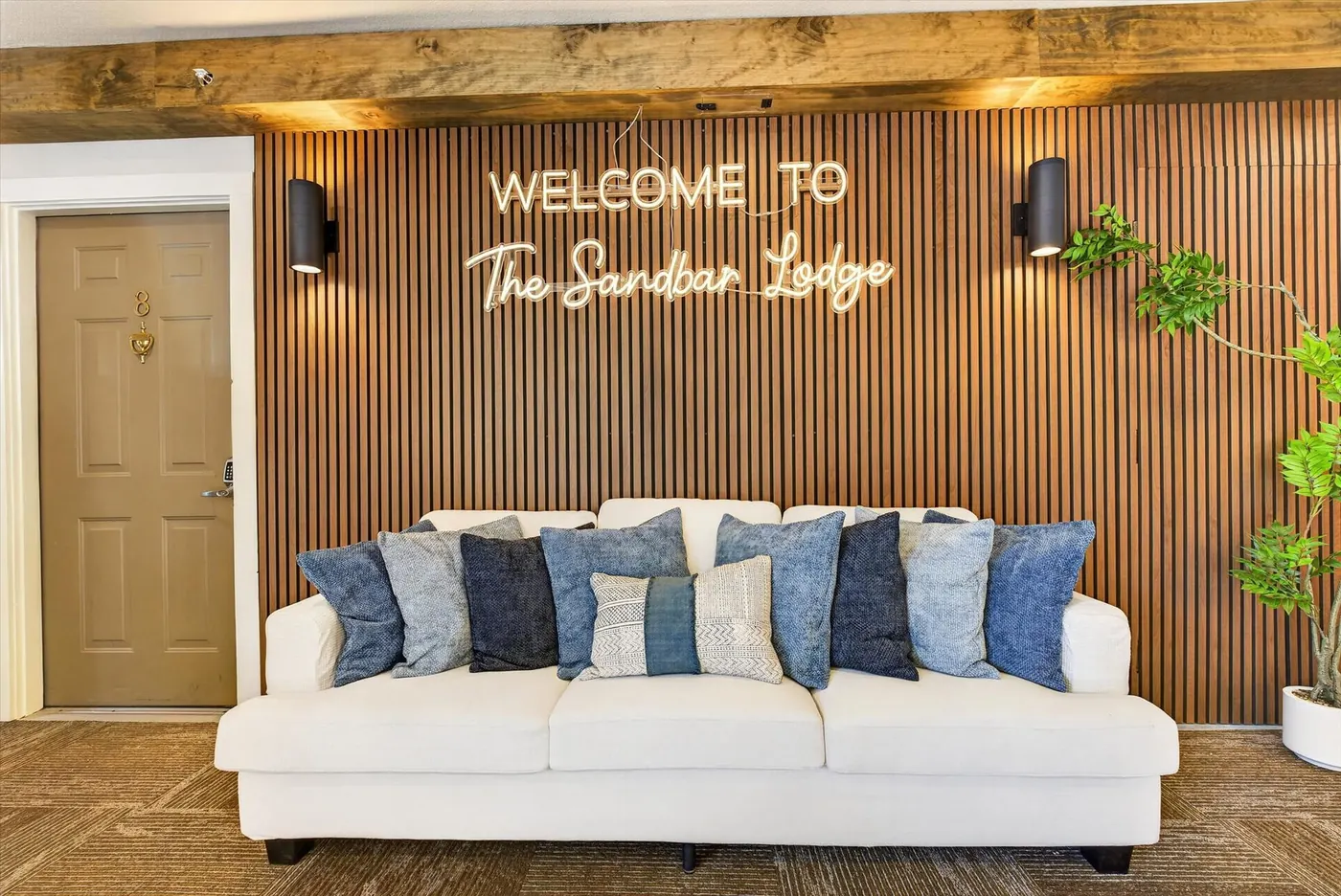 Sandbar Lodge sofa beneath the welcome sign