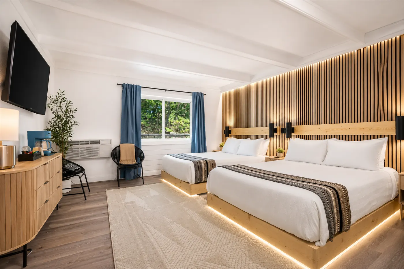 Two Queens lodge suite with two queen beds and wood accent wall