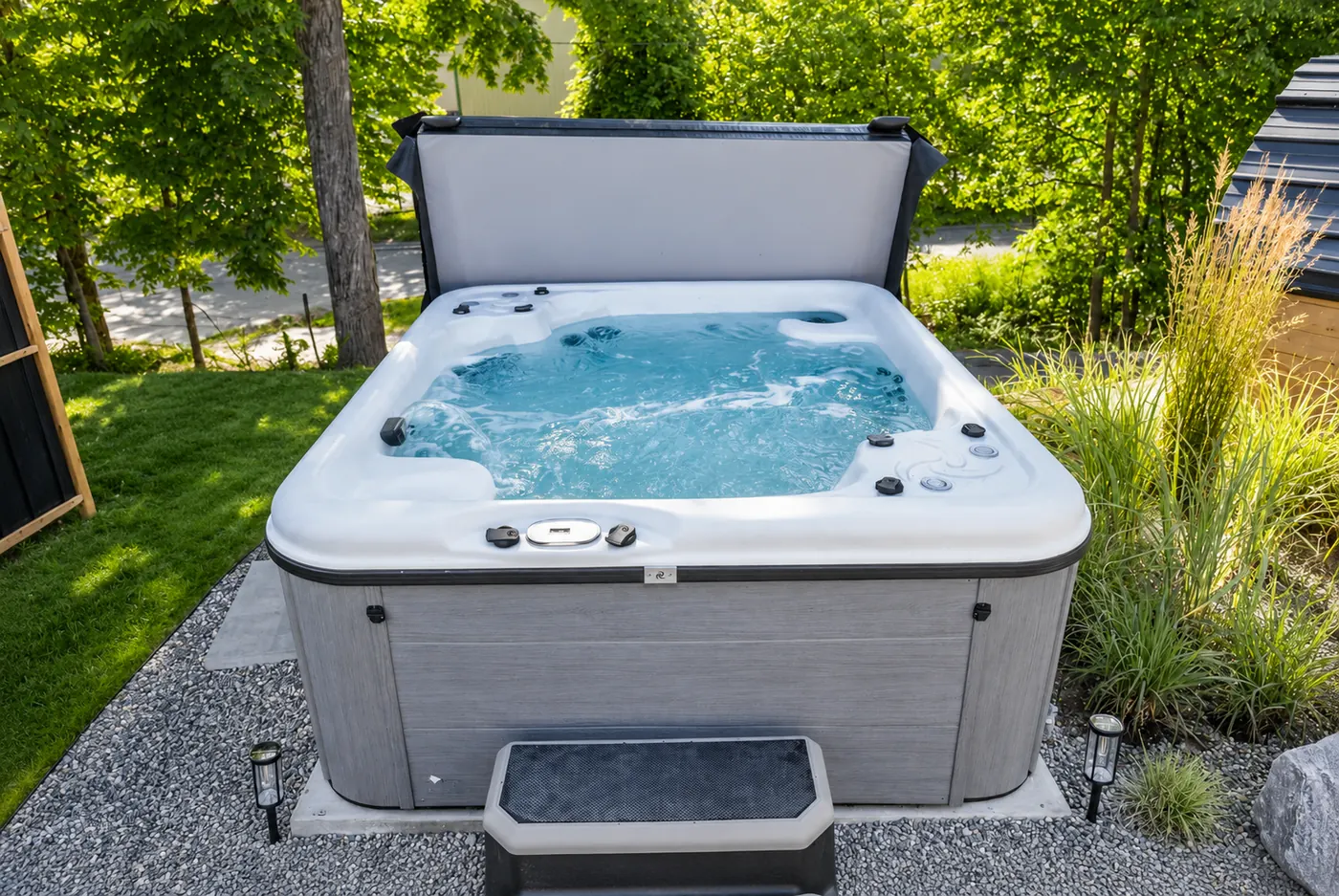 Outdoor hot tub surrounded by greenery
