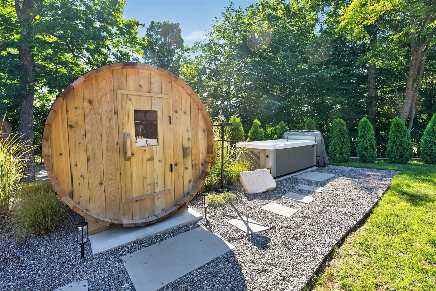 Barrel sauna and cold plunge in the outdoor wellness area