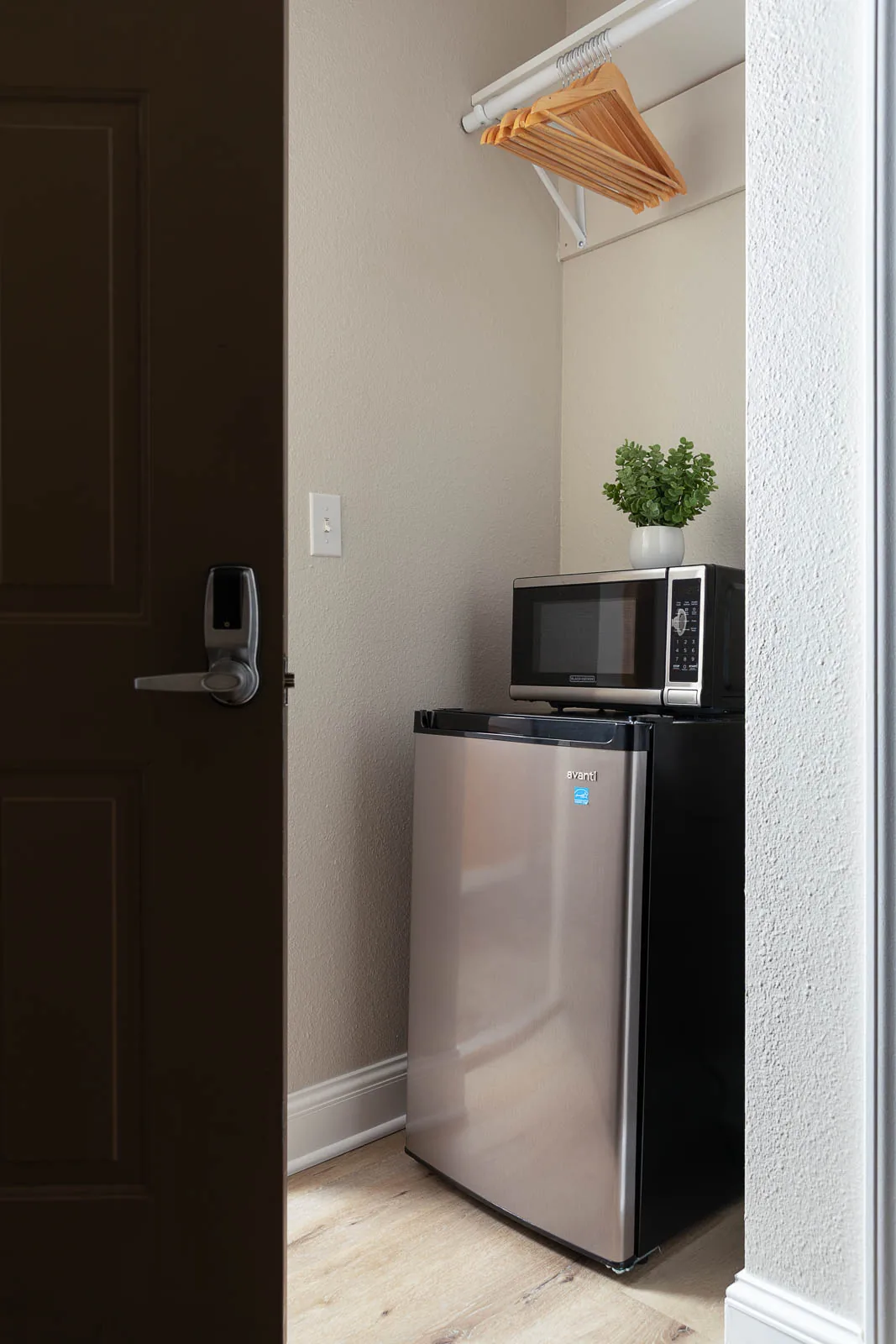 Mini fridge, microwave, and hanging area in the Two Queens Lodge Suite