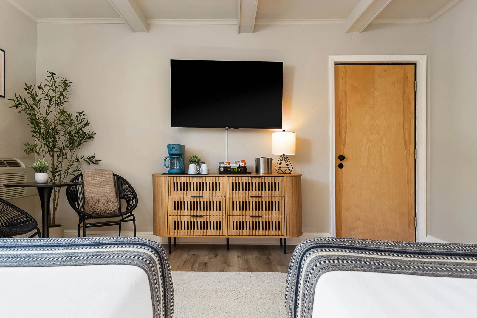 Two Queens Lodge Suite Smart TV, dresser, and coffee station